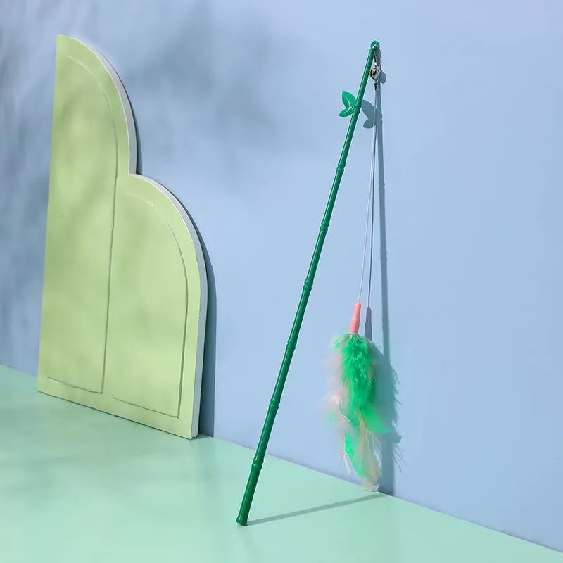 Interactive cat toy feather wand with green bells and feathers on a durable wand