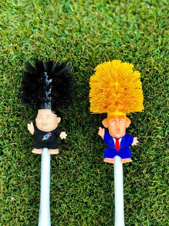Yellow plastic Donald Trump toilet brush with handle slot, 40cm length, on white background