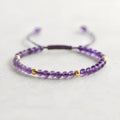Handmade 4mm natural amethyst bracelet with 14K gold plated accents on a white background