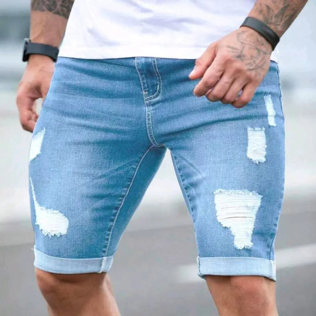 Men's sky blue denim shorts with multi-hole design, low waist, straight fit, and zipper fly on a hanger