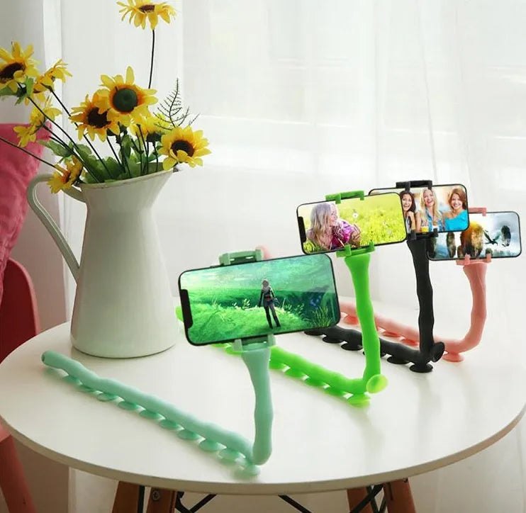 Black flexible worm arm phone holder with suction cup extended, showing 360-degree rotating bracket.