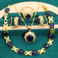 Four piece 18K gold plated jewellery set with coloured cubic zirconia stones including necklace earrings ring and bracelet