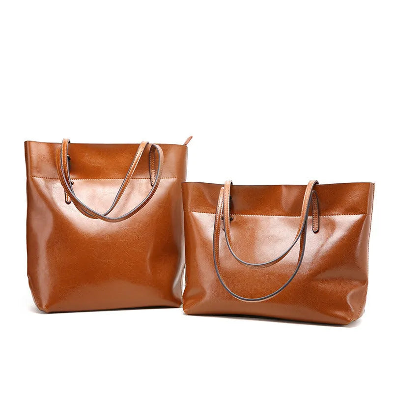 Brown waxed cowhide leather crossbody handbag shown horizontally, displaying two main compartments and a front phone pocket.