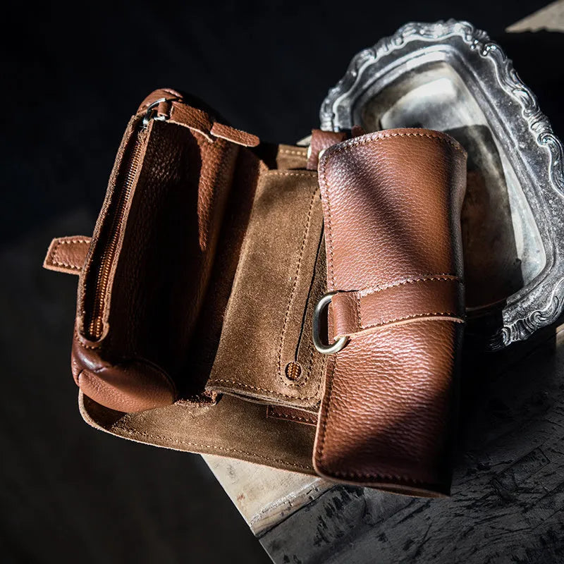 Handmade vintage style leather wallet in black, showing tape extraction closure.