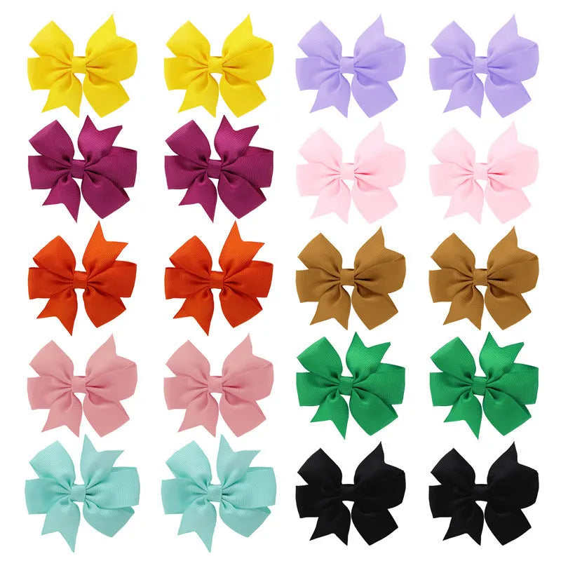 Grosgrain ribbon pinwheel hair bow 3 inches with alligator clip on light background
