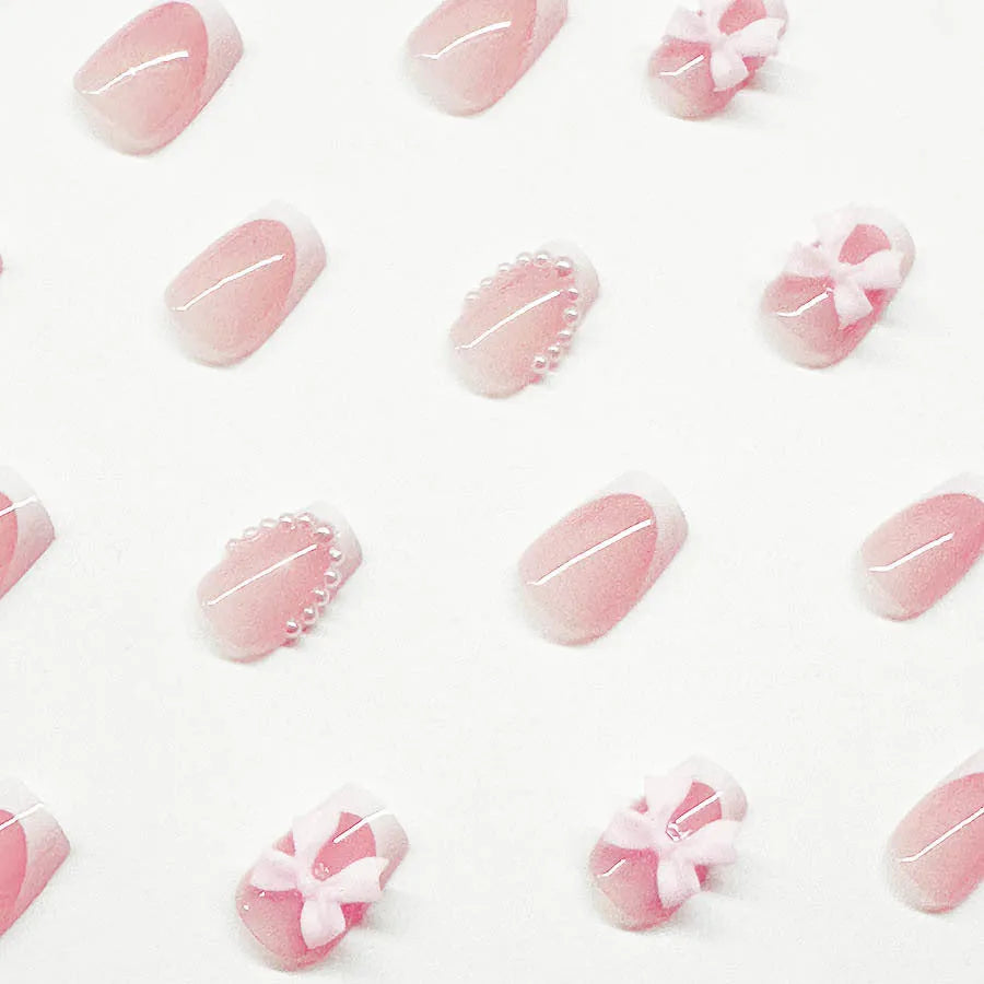 Set of short false nails with white French manicure, tulip, bow, starry sky, and leopard print designs.