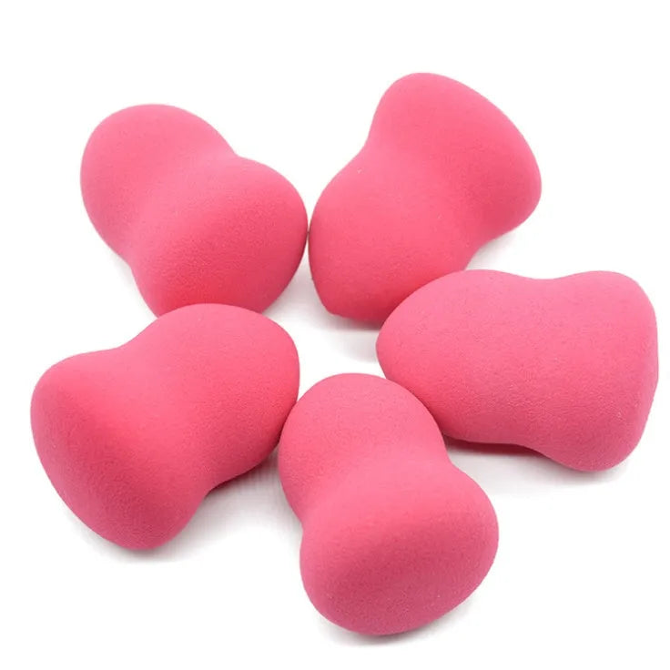Pink hydrophilic non-latex makeup foundation sponge puff on a white background