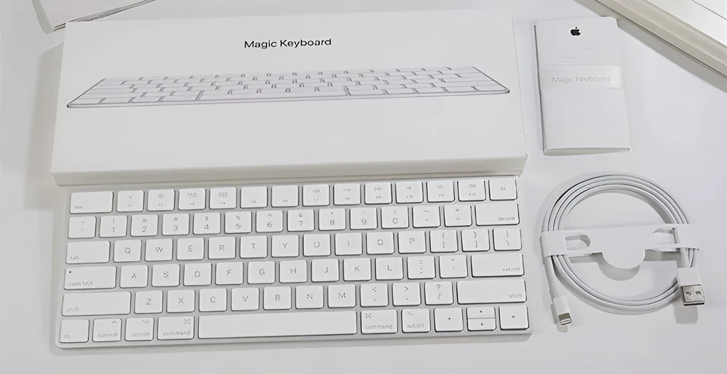 Apple ultra-thin metal Bluetooth wireless keyboard in white on a desk.