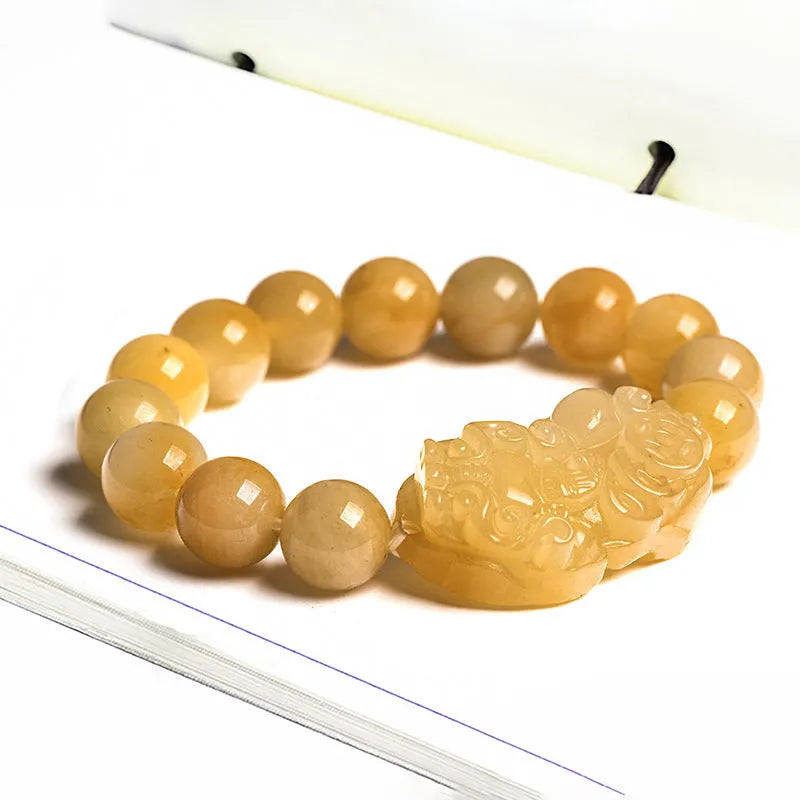Carved golden thread jade money bracelet with traditional Chinese design showing detailed money motifs