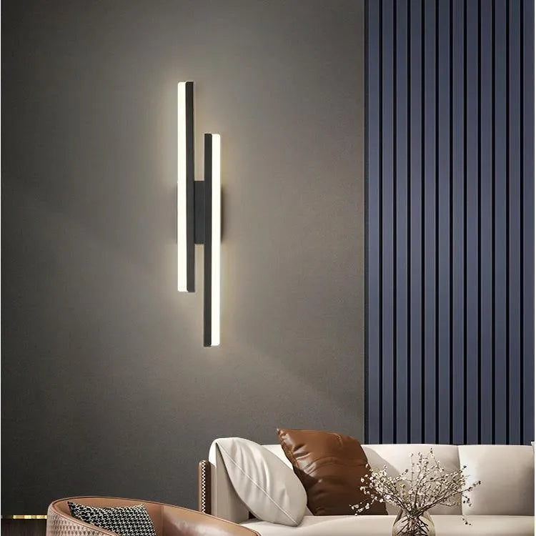 Scandinavian minimalist LED wall light with acrylic shade on black metal arm.