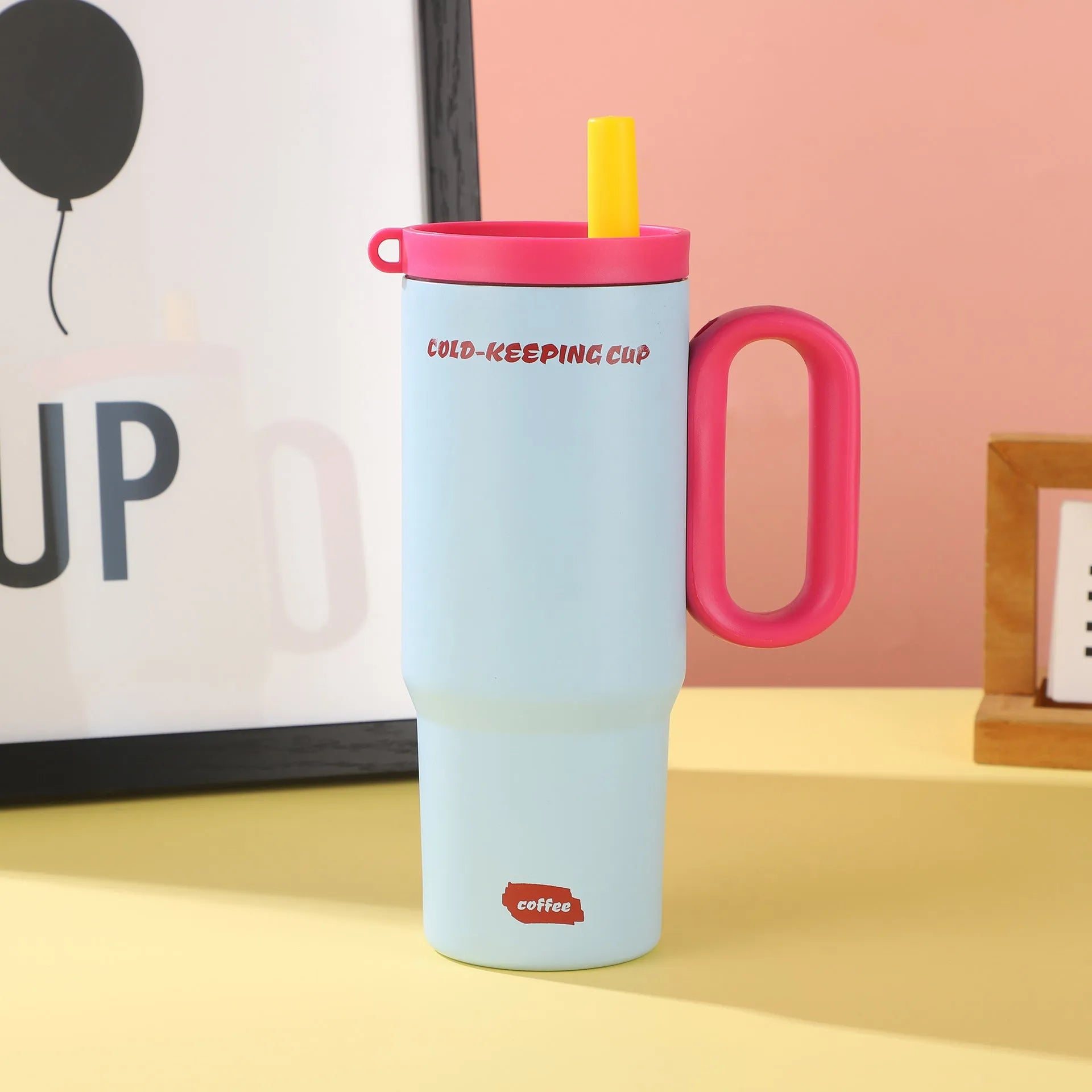 Portable insulated drink cup with carry handle and straw lid in multiple colours
