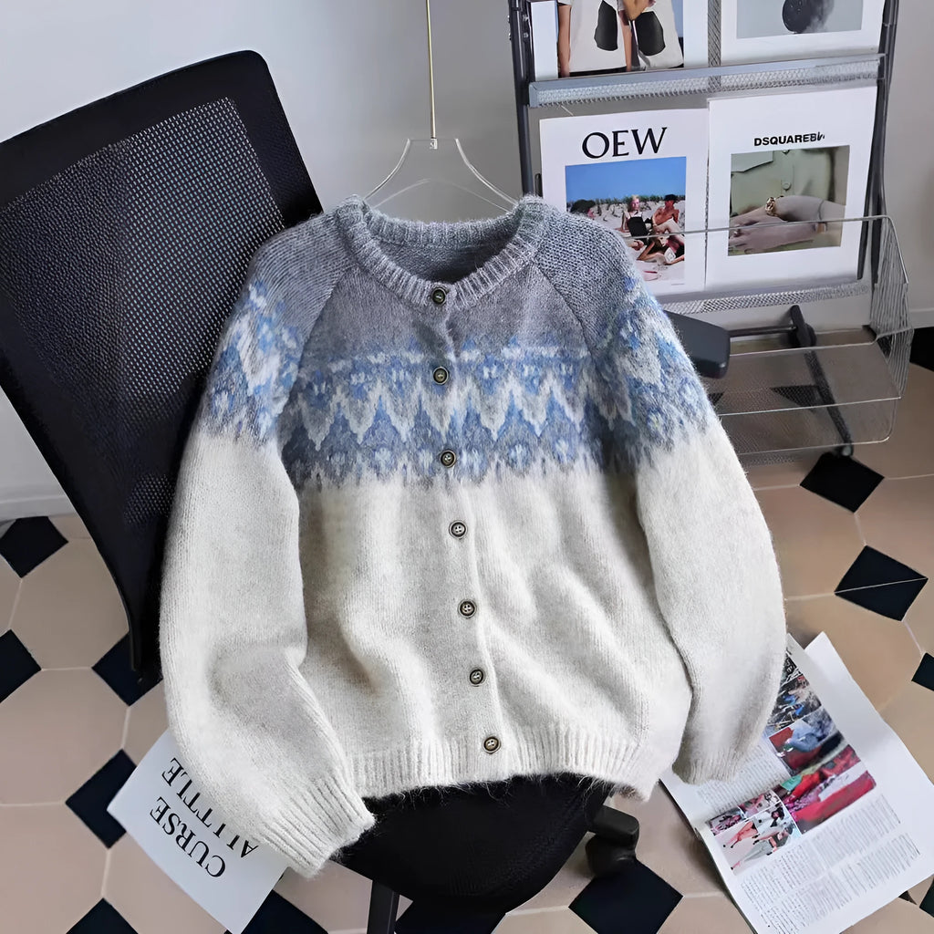 Women's beige jacquard knit sweater coat with loose fit and long sleeves on a hanger.