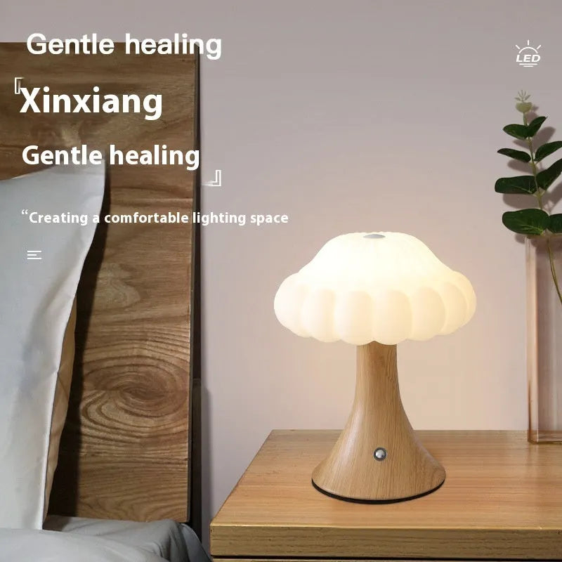 Small mushroom-shaped night lamp in wood grain colour with USB charging port and touch control.