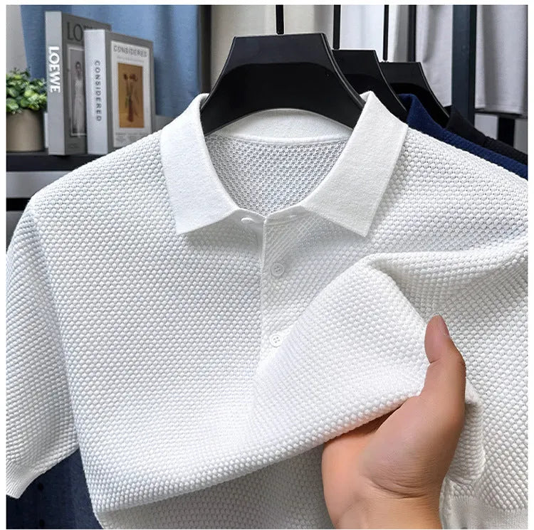 A loose short-sleeved cotton pullover sweater on a hanger, shown in a solid colour.