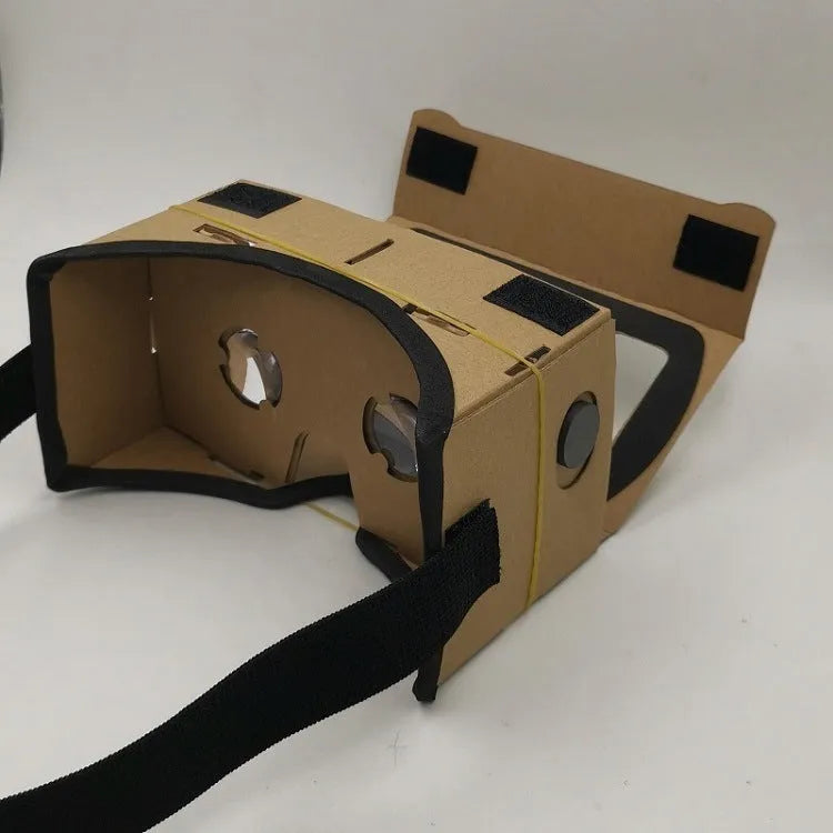 Pink and white cardboard VR headset for smartphones with adjustable straps and 3D lenses.