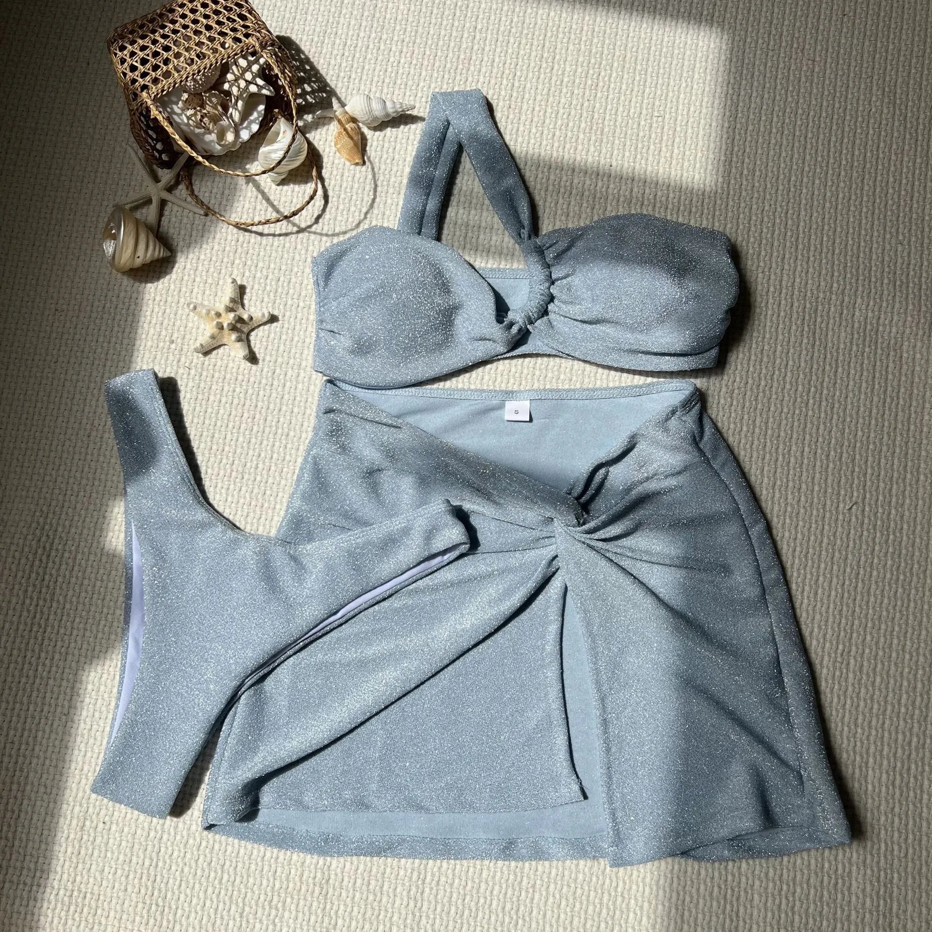 Light green one-shoulder tube top swimsuit set with matching bikini bottom and skirt.