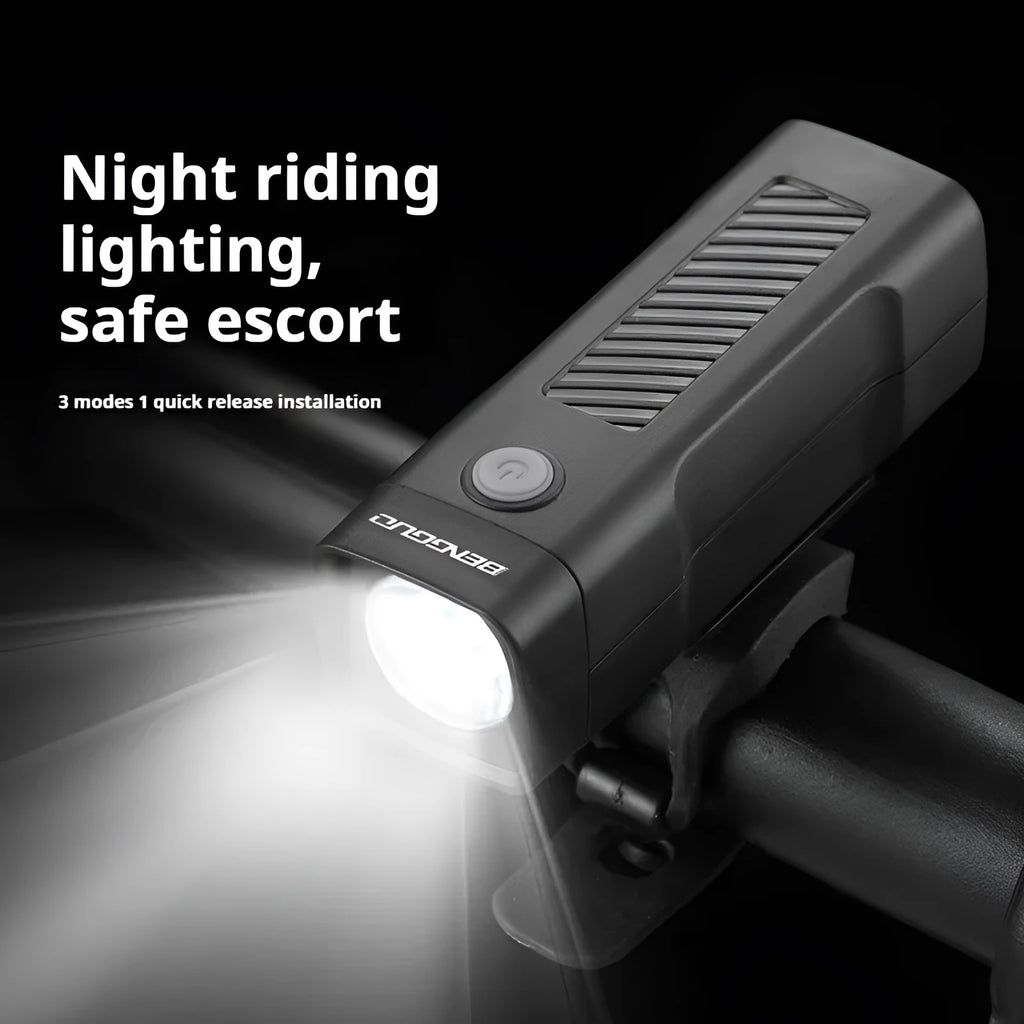 Black USB-rechargeable bicycle headlight mounted on bike handlebars with strap bracket.