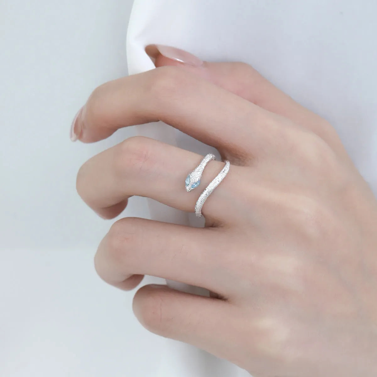 Adjustable silver snake ring with white gold electroplated finish showing detailed serpent modelling