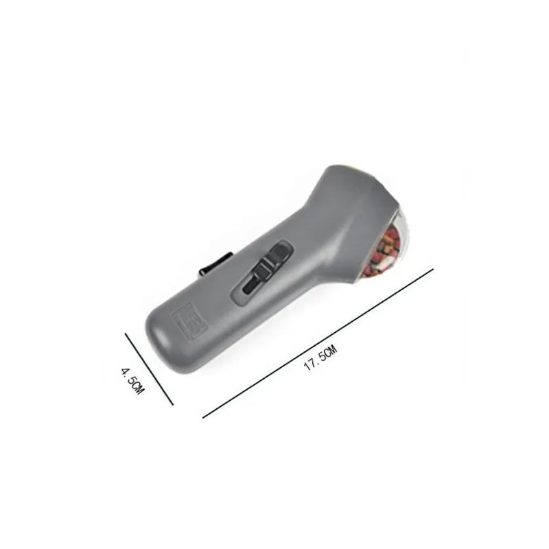 Grey pet snack catapult launcher showing spring trigger mechanism and compact 18cm design