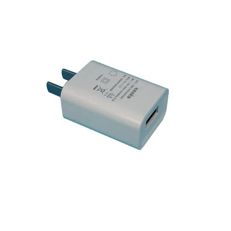 White 5V 1A USB wall charger with UK plug and CE FCC marks.