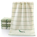 Pure cotton 32 strand embroidered face washing towel 34x74cm in green on a white background