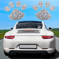 Diamond-encrusted car sticker showing bear paw and butterfly designs on glass with drill stick