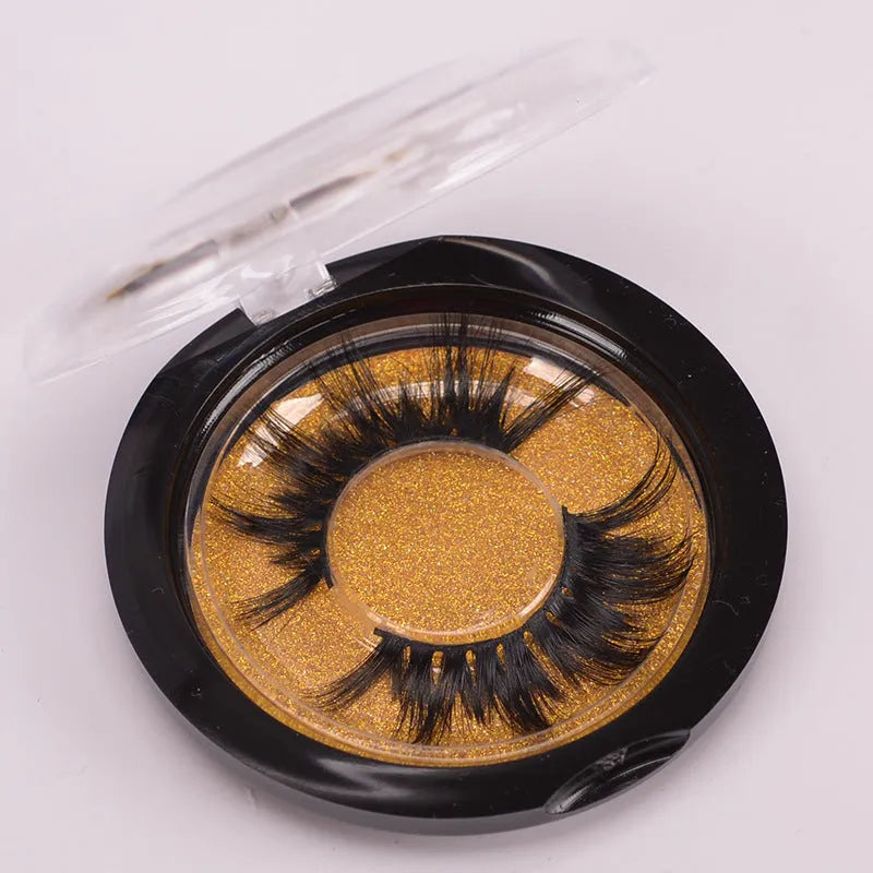 A pair of 5D mink false eyelashes with a double-headed brush and a black hair storage cap on a white background.