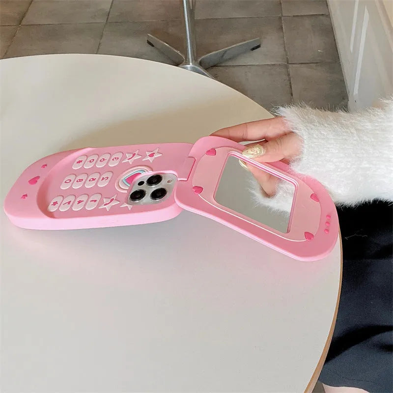 Light pink silicone flip phone case for iPhone with a built-in mirror on the front.