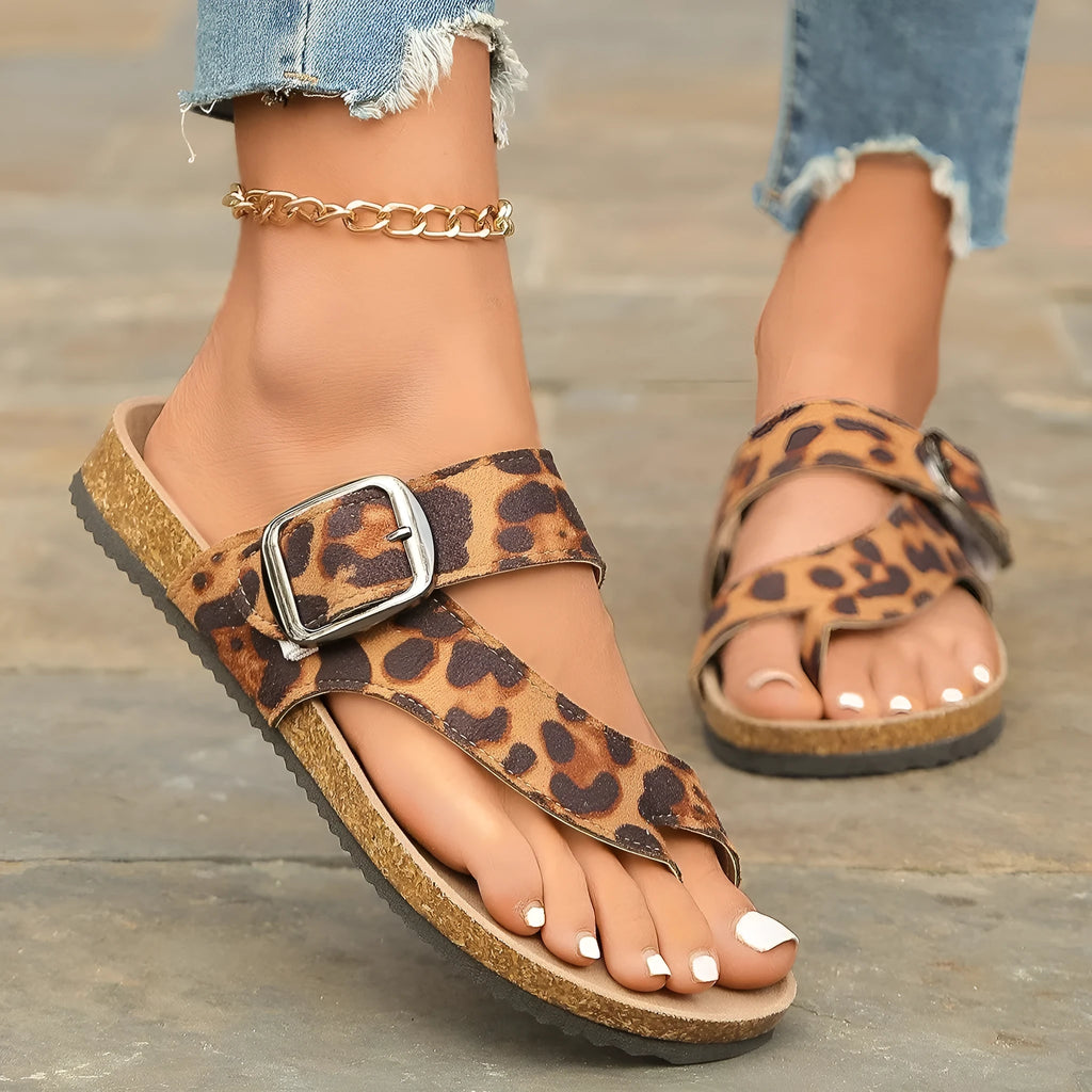 Roman style toe covering leopard slippers with wooden sole on neutral background