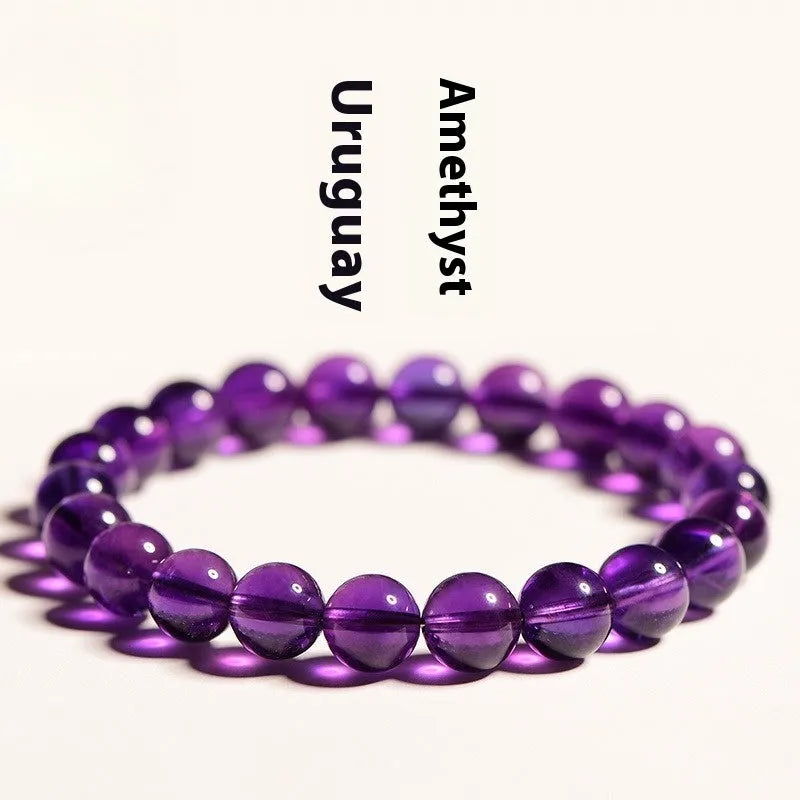 Natural Uruguayan amethyst scattered beads bracelet in various grades and sizes on a white background.