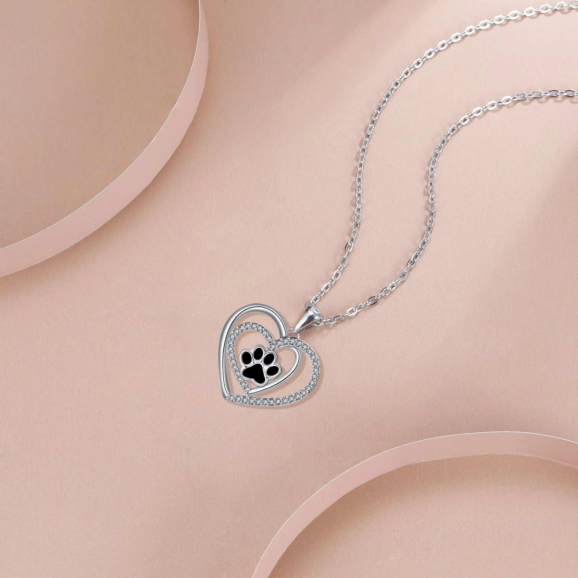 Women's silver-tone necklace with dog paw footprint pendant on cross chain