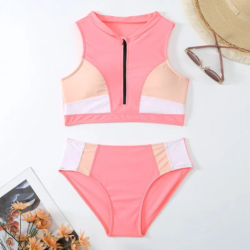 Pink high-waist bikini swimsuit with briefs style shorts and sleeveless top on a neutral background.
