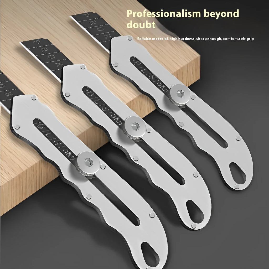 Stainless steel folding art knife with black blade and 20 spare blades on a work surface