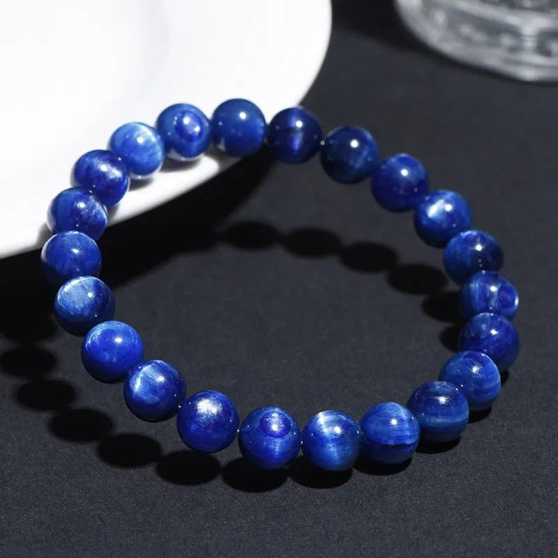 Natural grade 7A blue crystal ball bracelet with geometric beads and a Ruyi charm on a white background.