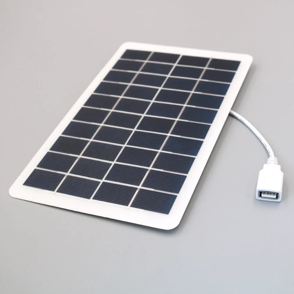 Portable black solar panel mobile phone charger with USB output and PET surface
