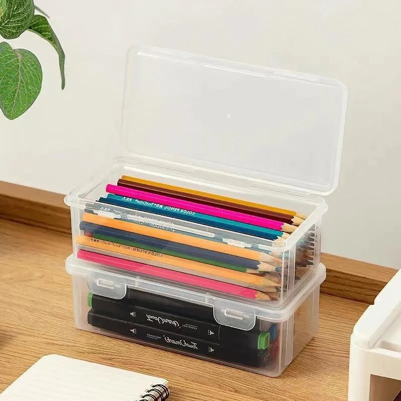 Large transparent plastic stationery storage box filled with colour pencils and crayons.