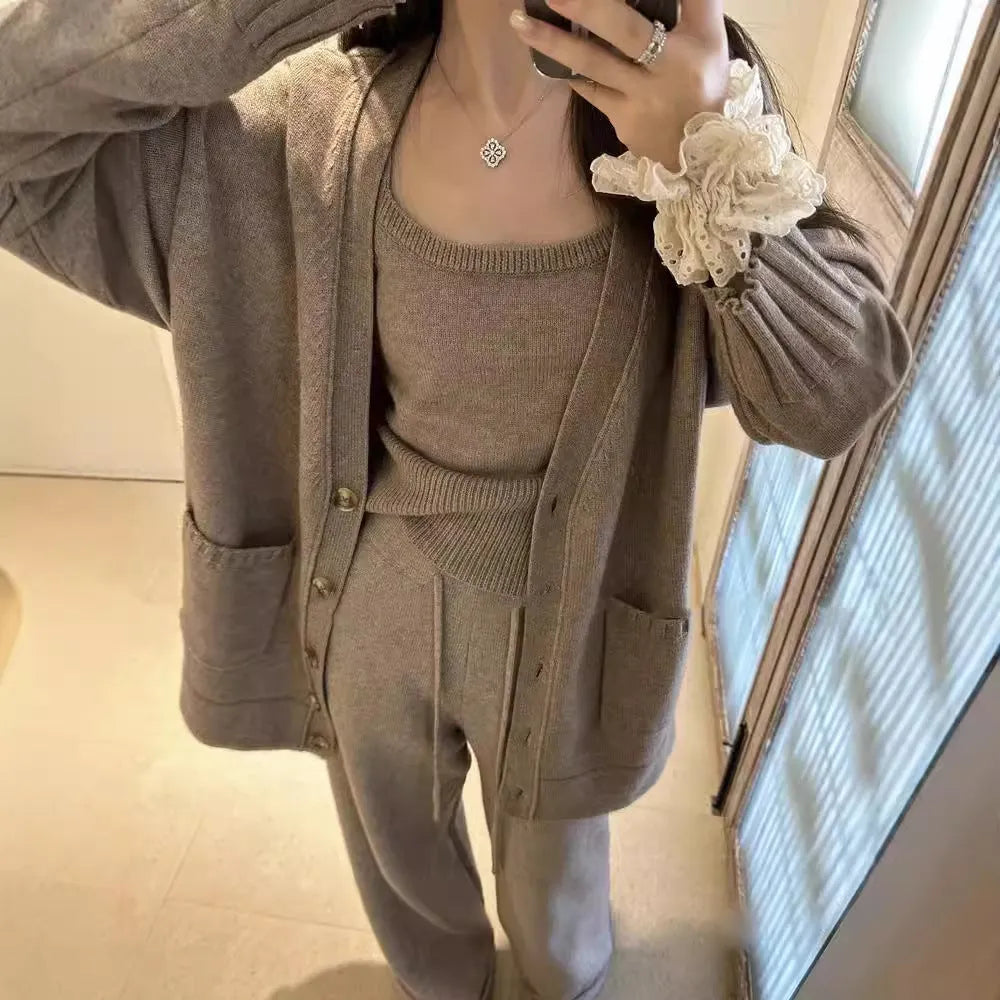 Women's light brown wool-blend knit cardigan vest and loose trousers three-piece set laid flat