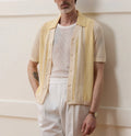 Yellow men's short-sleeve polo shirt with hollow-out design and asymmetric cut.