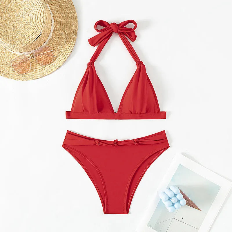 Red women's lace-up halterneck bikini with split design and matching shorts