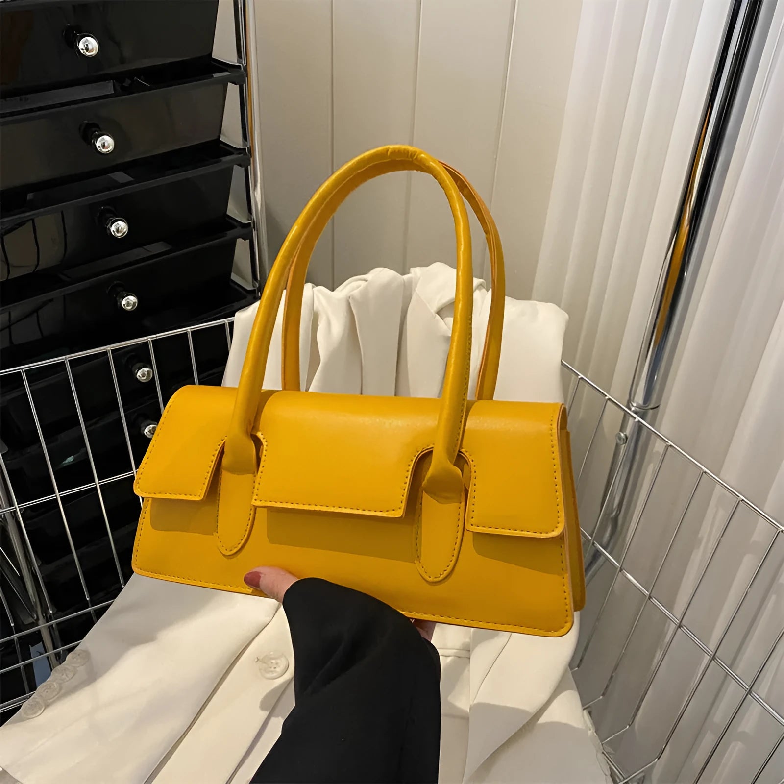 Women's retro style small square PU shoulder bag in black with visible stitching and a single strap