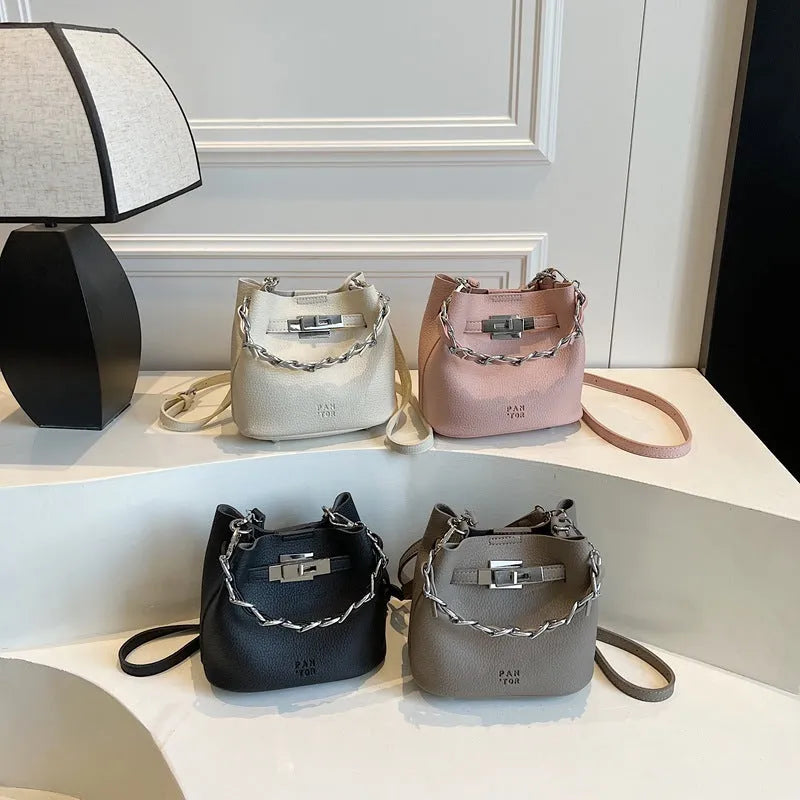 Soft PU retro bucket bag with chain detail on woman's shoulder