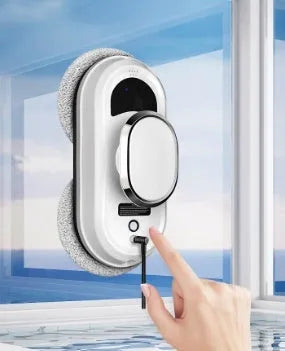 White full-automatic high-altitude cleaning machine with remote control on a window.