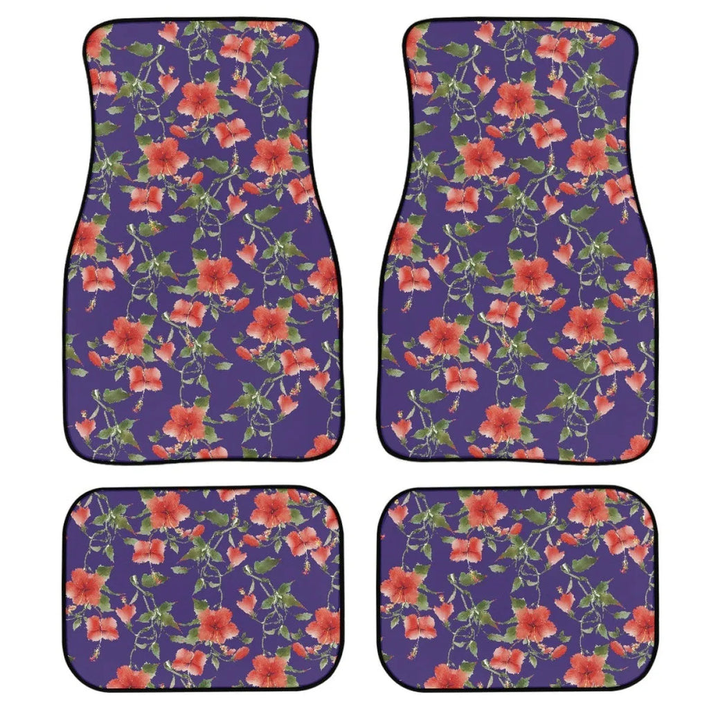 Black four-piece rubber car floor mat set with textured surface, shown fitted in a vehicle footwell.