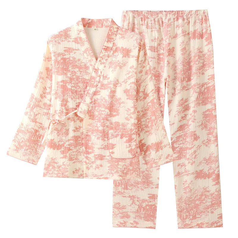Women's pink cotton gauze lounge suit set with long sleeve top and trousers on a hanger.