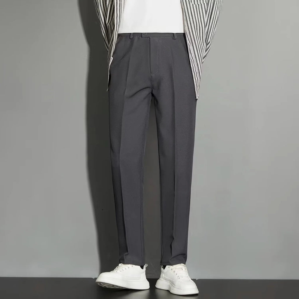 Men's straight-fit ankle-length suit trousers in a light gray colour, showing the draping effect.