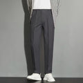 Men's straight-fit ankle-length suit trousers in a light gray colour, showing the draping effect.