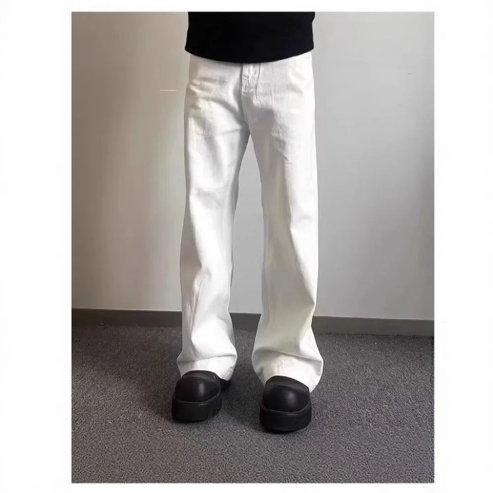 Men's loose fit straight leg white denim jeans on a hanger, showing wide leg opening and zipper fly.