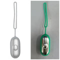 Hand-held micro-current sleep aid device in grey, with round button and micro USB port, on a desk