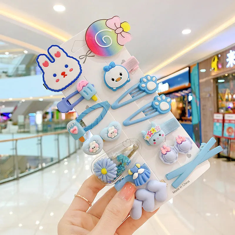 14-piece toddler hair accessories set on display including rainbow barrettes, fruit clips, and butterfly pins in bright colours