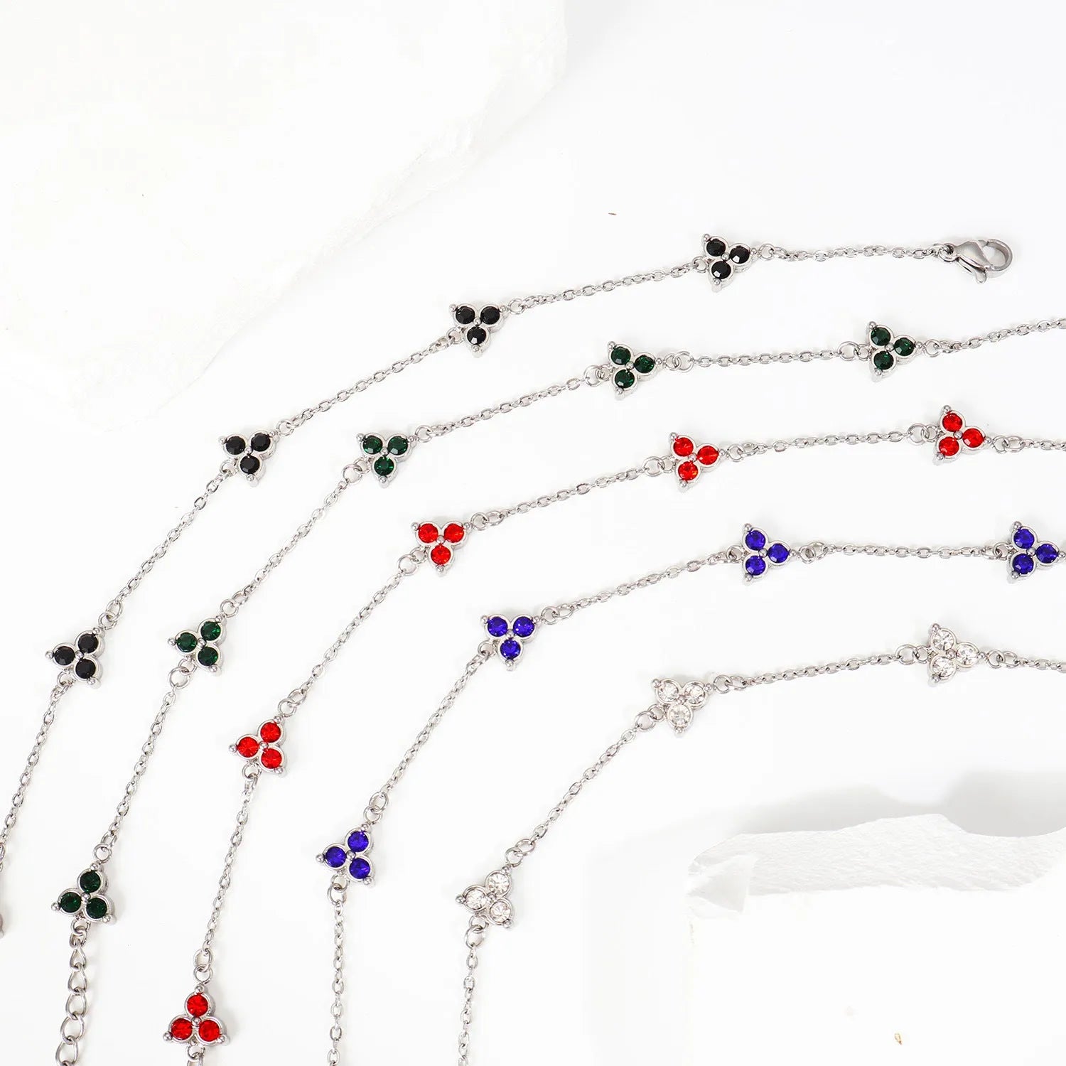 Women's stainless steel bracelet with three triangular diamond charms in geometric design with coloured stones